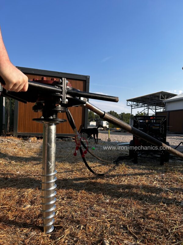 Hand held helical pile driver Falcon on a construction site