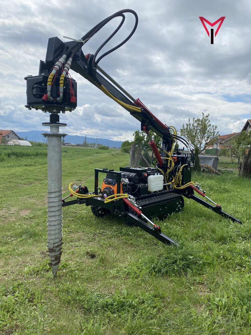 Hydraulic ground screw driver installing a screw pile