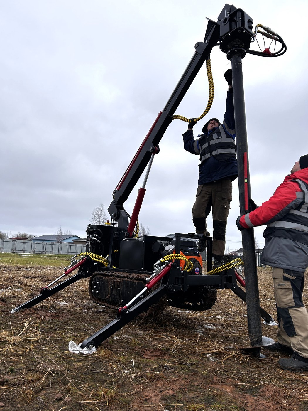 Crawler hydraulic helical pile machine installing a screw pile