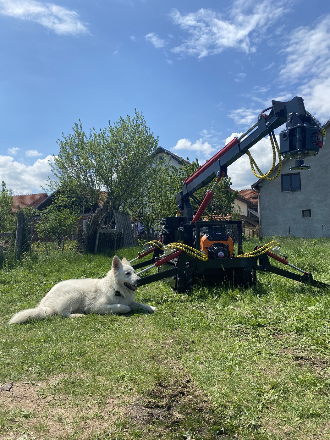Self-propelled hydraulic helical pile machine with dog on construction site
